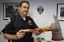 Akron Police Lt. Rick Edwards proudly displays a rubber Halloween axe his police thugs arrested Bill Morrison for possessing - Jesus, don't the pigs in Akron Ohio have any real criminals to hunt down?